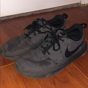 Black with white specks Nike Roshes.